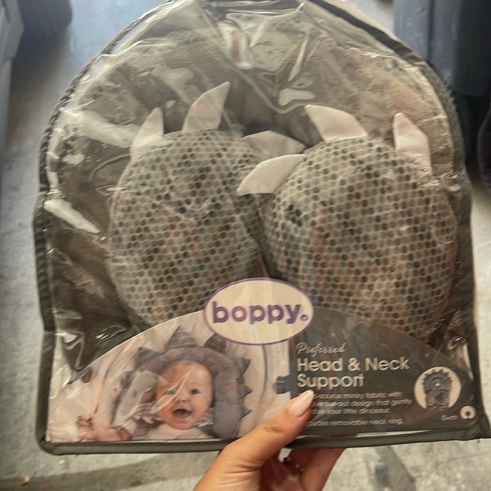 Boppy dinosaur head and neck support never used in original packaging.